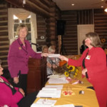 Director Rita Moore awards Camellia Garden Club, Clayton member Betty Lee as former District VII Director Peggy Williams looks on.